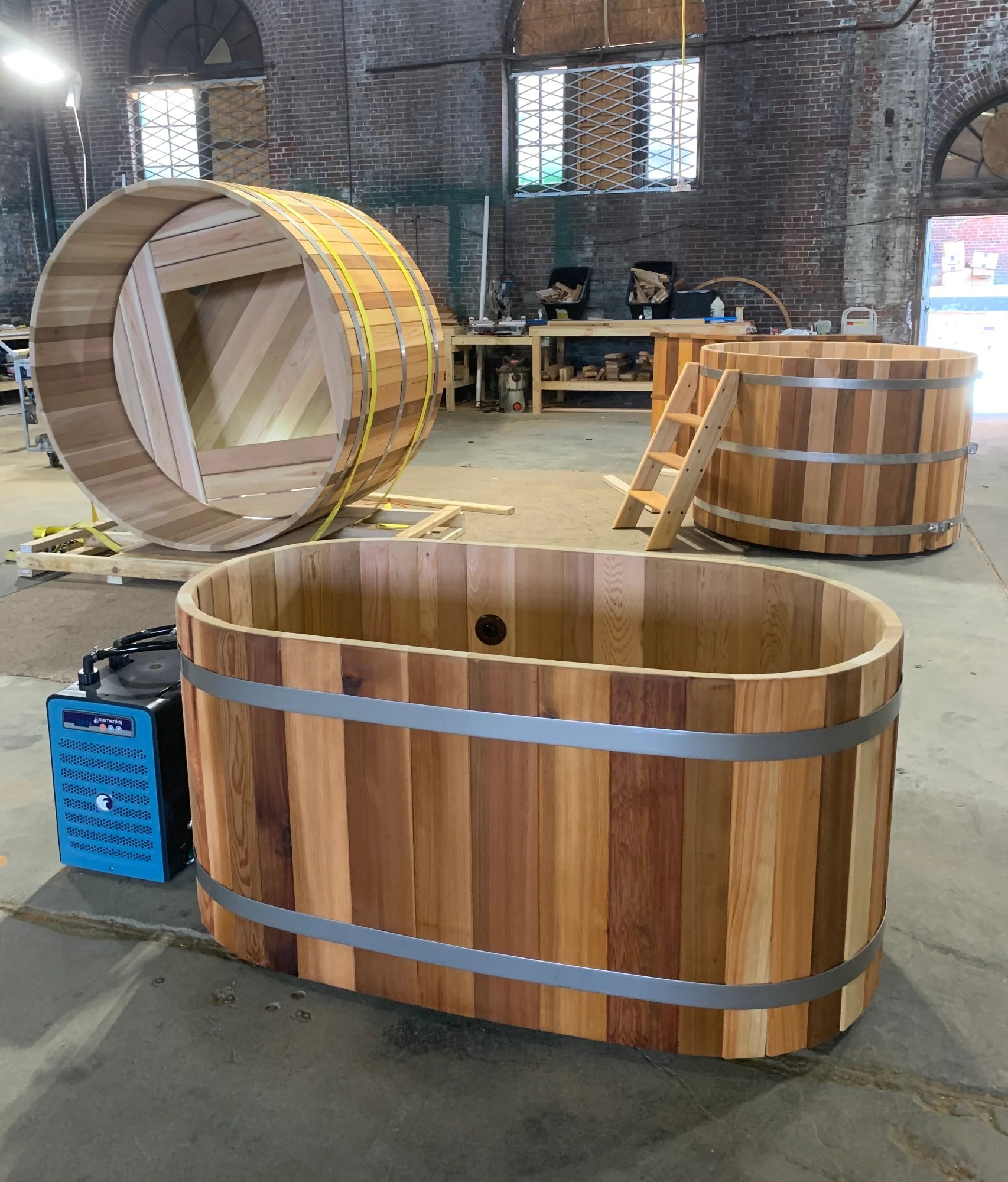 cedar cold plunge with chiller unit and barrel sauna on the Satori workshop floor